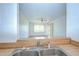View from the kitchen sink into the bright living room with a ceiling fan and patio door at 11511 113Th St # 33D, Largo, FL 33778