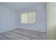 Bright living room features wood-look floors, a ceiling fan, and a large window for natural light at 11511 113Th St # 33D, Largo, FL 33778