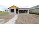 New construction of the home with block walls, garage space, and a stone walkway at 11858 Richmond Trl, Parrish, FL 34219