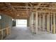 Framing of the large open space, revealing the design of the ceiling, windows, and garage opening at 11858 Richmond Trl, Parrish, FL 34219