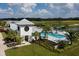 Aerial view of community pool area with seating, landscaping, and clubhouse at 11858 Richmond Trl, Parrish, FL 34219