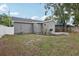 Backyard featuring a large grassy area with a deck, perfect for outdoor enjoyment and entertaining at 120 W Sligh Ave, Tampa, FL 33604