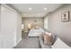 Cozy bedroom with a neutral palette, small couch, closet, and large window for natural light at 120 W Sligh Ave, Tampa, FL 33604