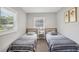Cozy bedroom with twin beds, offering a comfortable retreat at 120 W Sligh Ave, Tampa, FL 33604