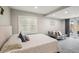 Bright bedroom with a large window, comfortable bed, and a cozy seating area with a gray daybed at 120 W Sligh Ave, Tampa, FL 33604