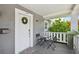 Inviting front porch with seating, a wreath, and a view of the charming neighborhood at 120 W Sligh Ave, Tampa, FL 33604