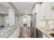 Well-lit kitchen with granite countertops and stainless steel appliances at 120 W Sligh Ave, Tampa, FL 33604