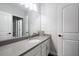Well-lit bathroom featuring a modern vanity with a gray countertop and white cabinets and neutral walls at 12415 Hitching St, Odessa, FL 33556