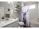 Well-lit bathroom featuring a shower and tub combination with stylish shelving at 12415 Hitching St, Odessa, FL 33556