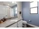 Bright bathroom featuring a modern vanity with quartz countertops, wood look floors, and a window for natural light at 12415 Hitching St, Odessa, FL 33556