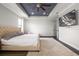 Spacious main bedroom with a ceiling fan, dark floors, and a large tv hung on the wall at 12415 Hitching St, Odessa, FL 33556