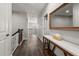 Upstairs hallway with wood floors and a stylish console table and mirror at 12415 Hitching St, Odessa, FL 33556