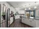 Modern kitchen with a center island, stainless steel appliances, and wooden flooring at 12415 Hitching St, Odessa, FL 33556