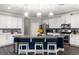 Spacious white kitchen with stainless steel appliances, dark wood floors, and barstool seating at 12415 Hitching St, Odessa, FL 33556