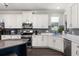 Bright kitchen features stainless steel appliances and white cabinets at 12415 Hitching St, Odessa, FL 33556