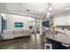 Spacious open-concept living room with wood floors and modern lighting fixtures at 12415 Hitching St, Odessa, FL 33556