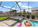 Enclosed pool area with a hot tub, playful floats, and a clear blue sky overhead at 12415 Hitching St, Odessa, FL 33556