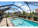 Enclosed pool area with a hot tub, playful floats, and a clear blue sky overhead at 12415 Hitching St, Odessa, FL 33556