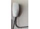 Close-up of a Tesla charger mounted on a textured wall with conduit piping at 12415 Hitching St, Odessa, FL 33556