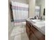 Cozy bathroom with decorative shower curtain and ample vanity counter space at 1247 Gentilly Ln, Wesley Chapel, FL 33544