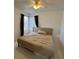 Bedroom featuring neutral walls, comfortable bed, and natural light with modern curtains at 1247 Gentilly Ln, Wesley Chapel, FL 33544