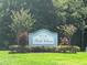 Entrance to Belle Chase community with attractive landscaping and flowering crepe myrtle trees at 1247 Gentilly Ln, Wesley Chapel, FL 33544