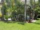 Landscaped front yard with green grass and lots of various flowers and plants at 1247 Gentilly Ln, Wesley Chapel, FL 33544