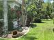 Landscaped front yard with green grass and lots of various plants and flowers at 1247 Gentilly Ln, Wesley Chapel, FL 33544