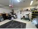 Functional two-car garage space offering extra storage shelves and a work area at 1247 Gentilly Ln, Wesley Chapel, FL 33544