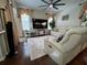 Bright living room with hardwood floors and cozy leather seating at 1247 Gentilly Ln, Wesley Chapel, FL 33544