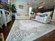 Spacious living room featuring modern furniture, a decorative rug, and hardwood floors at 1247 Gentilly Ln, Wesley Chapel, FL 33544
