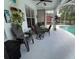 Covered patio featuring stylish outdoor seating, a ceiling fan, and decorative plants and shelves at 1247 Gentilly Ln, Wesley Chapel, FL 33544
