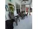 Covered patio featuring stylish outdoor seating, a ceiling fan, and decorative plants and shelves at 1247 Gentilly Ln, Wesley Chapel, FL 33544