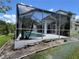 Exterior view of the house with a screened in pool and hot tub area at 1247 Gentilly Ln, Wesley Chapel, FL 33544