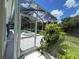 View of the screen pool enclosure with the hot tub and the pool inside at 1247 Gentilly Ln, Wesley Chapel, FL 33544