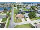 Aerial view of a waterfront property with canal access and a glimpse of the ocean in the distance at 13727 Gene Rossi Ave, Hudson, FL 34667