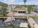Waterfront home featuring a boat lift and dock on a canal, providing convenient access to local waterways and canals at 13727 Gene Rossi Ave, Hudson, FL 34667