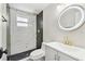 Modern bathroom showcases a stylish shower with marble tiles, sleek vanity with gold fixtures at 13727 Gene Rossi Ave, Hudson, FL 34667