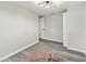 Bedroom features gray hardwood floors, area rug, modern light fixture, and closet at 13727 Gene Rossi Ave, Hudson, FL 34667
