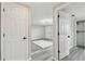 View from the hall showcasing the bedroom with stylish floors and a modern light fixture at 13727 Gene Rossi Ave, Hudson, FL 34667