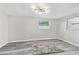 Bright bedroom featuring updated flooring, modern ceiling light, and a large window at 13727 Gene Rossi Ave, Hudson, FL 34667