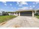 Exterior daytime view of the home and driveway with vehicle at 13727 Gene Rossi Ave, Hudson, FL 34667