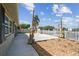 Exterior view of backyard with a gravel area, patio, and canal access at 13727 Gene Rossi Ave, Hudson, FL 34667