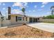 The house exterior features a chimney, a screened lanai, and a palm tree at 13727 Gene Rossi Ave, Hudson, FL 34667