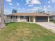 Inviting home with a lush green lawn, offering a comfortable and Gathering-friendly atmosphere at 13727 Gene Rossi Ave, Hudson, FL 34667