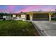 Exterior daytime view of the home and driveway showcasing blue sky at 13727 Gene Rossi Ave, Hudson, FL 34667
