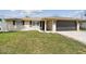 Charming single-story home with a well-manicured lawn and an attached two-car garage at 13727 Gene Rossi Ave, Hudson, FL 34667