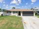 Well-maintained single-Gathering home with a spacious front yard and a convenient two-car garage at 13727 Gene Rossi Ave, Hudson, FL 34667