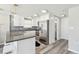 Bright modern kitchen with white cabinets, stainless appliances and view into bathroom at 13727 Gene Rossi Ave, Hudson, FL 34667
