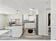 Bright modern kitchen with island, white cabinets, stainless appliances and pendant lighting at 13727 Gene Rossi Ave, Hudson, FL 34667